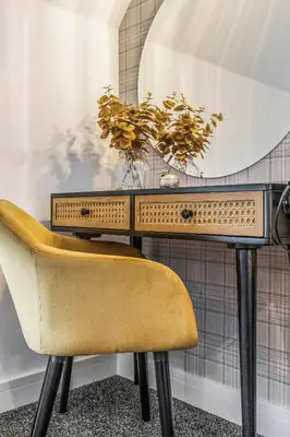 a desk with a yellow chair and a mirror at Parkside 2 bedroom house near Dunfermline & Edinburgh in Dunfermline
