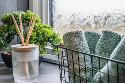 a cup with wooden sticks in it next to plants at Parkside 2 bedroom house near Dunfermline & Edinburgh in Dunfermline