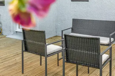two wicker chairs and a table in a room at Parkside 2 bedroom house near Dunfermline & Edinburgh in Dunfermline