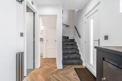 a hallway with a staircase in a house at Parkside 2 bedroom house near Dunfermline & Edinburgh in Dunfermline
