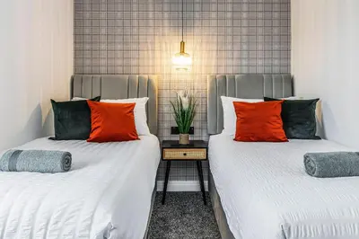 two beds sitting next to each other in a room at Parkside 2 bedroom house near Dunfermline & Edinburgh in Dunfermline