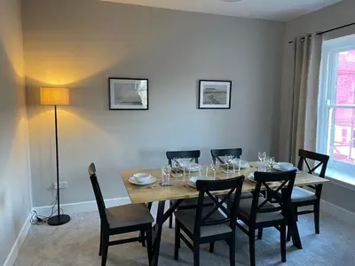 a dining room with a wooden table and chairs at Stunning Apartment in Callander in Callander