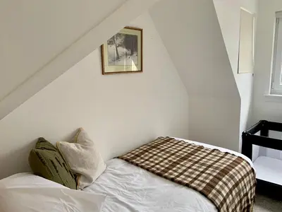 a bedroom with a bed with a blanket on it at Stunning Apartment in Callander in Callander