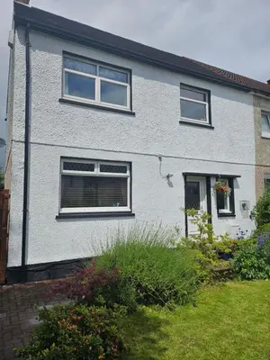a white house with windows and a yard at Spacious 2 bedroom house on the edge of Balloch in Balloch