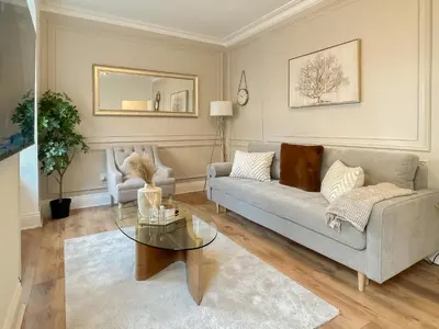 a living room with a couch and a table at Cozy 1 bed Blythswood Apartment in Glasgow