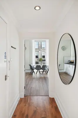 a hallway with a mirror and a dining room at (G1) Elegant 2 bed Blythswood Apartment in Glasgow