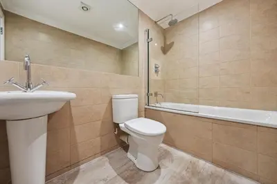 a bathroom with a toilet and a sink and a tub at (G1) Elegant 2 bed Blythswood Apartment in Glasgow