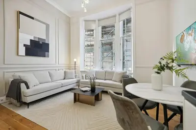 a living room with a white couch and a table at (G4) Luxurious 2 Bed Blythswood Flat in Glasgow