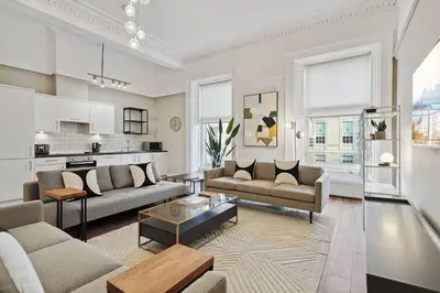 a living room with two couches and a table at (G5) Grand 1 bed Blythswood Apartment in Glasgow