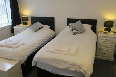 two beds sitting next to each other in a room at Cumbrae View House (Licence no NA00109F) in Largs