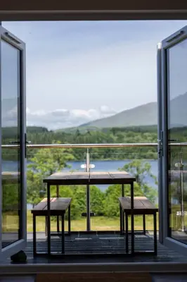 a table and two chairs in front of a window at Blar Cottage (Private Sauna + Fast Starlink Wifi) in Hayfield