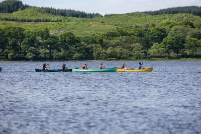 a group of people in kayaks on a lake at Blar Cottage (Private Sauna + Fast Starlink Wifi) in Hayfield