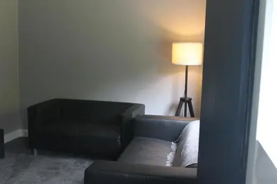 a living room with a couch and a lamp at Garnock 1 in Beith