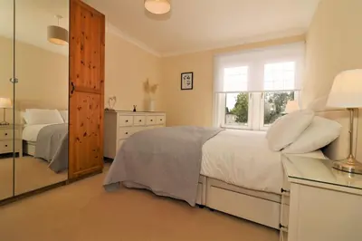 a bedroom with a bed and a window and a mirror at Signature - Lincoln View in Knightswood