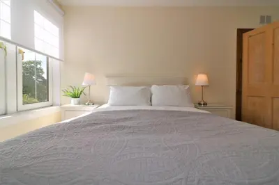 a bedroom with a large bed with two windows at Signature - Lincoln View in Knightswood