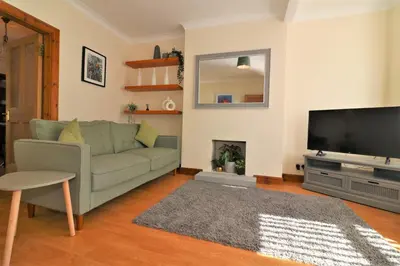 a living room with a couch and a flat screen tv at Signature - Lincoln View in Knightswood