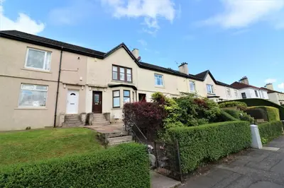 a row of houses with bushes in front of them at Signature - Lincoln View in Knightswood