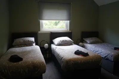 a bedroom with two twin beds and a window at Garnock 2 in Beith