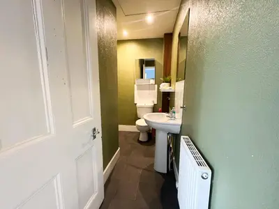a bathroom with a white sink and a toilet at Cozy Studio Apartment of Glasgows West End in Glasgow
