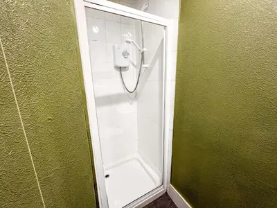 a shower with a glass door in a bathroom at Cozy Studio Apartment of Glasgows West End in Glasgow