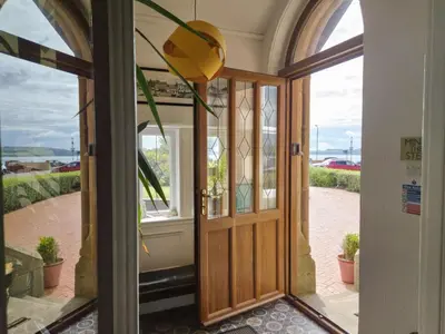 an entrance to a house with a wooden door at The Old Rectory in Largs