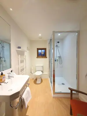 a bathroom with a shower and a sink and a toilet at Edinburgh 2-Bedroom Cottage with Parking - Ground Floor in Edinburgh