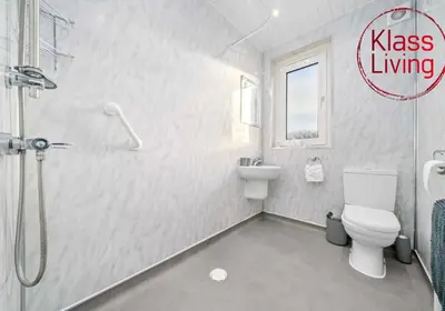 a bathroom with a shower and a toilet and a sink at Uddingston Apartment by Klass Living in Uddingston