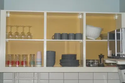 a cabinet filled with plates and bowls and dishes at Garnock 3 in Beith