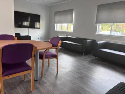 a living room with a table and chairs and a couch at Garnock 3 in Beith