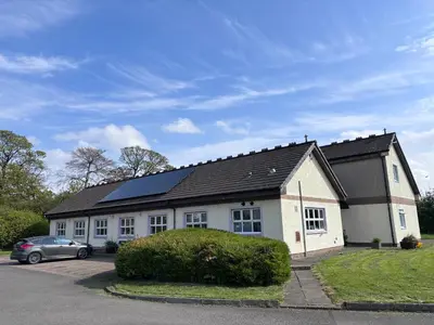 a large white house with a car parked in front of it at Garnock 3 in Beith