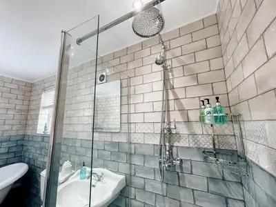 a bathroom with a shower and a sink at Otterburn House in Rothesay