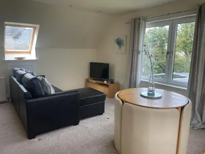 a living room with a couch and a table at Robin's Rest in Auchterarder