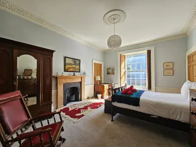 a bedroom with a bed and a fireplace at Unique Edinburgh New Town Apartment near Princes Street in Edinburgh