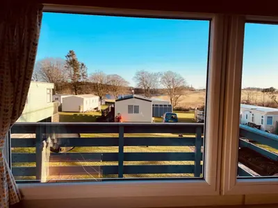 a window with a view of a yard at Newton Stewart-Sleeps 6-Pool-Parking-Pet Friendly in Newton Stewart