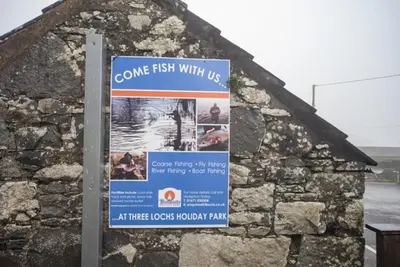 a sign on the side of a building at Newton Stewart-Sleeps 6-Pool-Parking-Pet Friendly in Newton Stewart