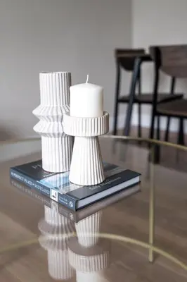 a table with a candle on top of a book at Shaw Apartment in Glasgow