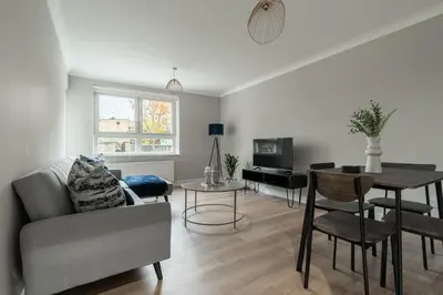 a living room with a couch and a table at Shaw Apartment in Glasgow