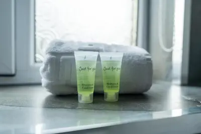 two bottles of moisturizing cream sitting on a counter at The Bowhouse in Grangemouth