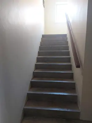 a staircase in a building with a stair case at The Blossom - Largs in Largs