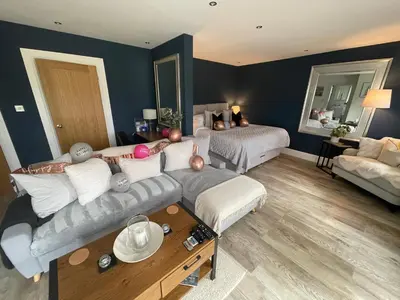a living room with a couch and a bed at Mackie lodge in Luss