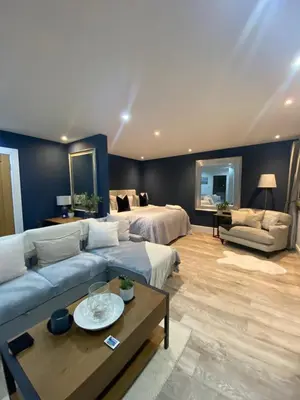a living room with a couch and a bed at Mackie lodge in Luss