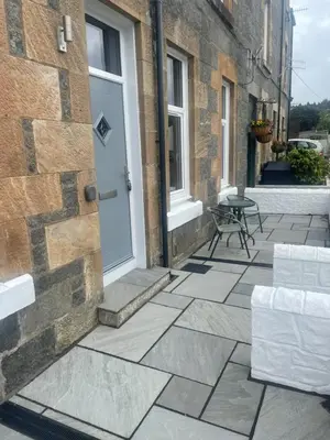 an outdoor patio with a door and a table at Springlea in Oban