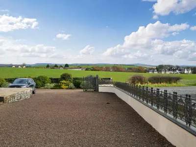 a bridge over a road with a car on it at The Old Cheese Loft in Colfin
