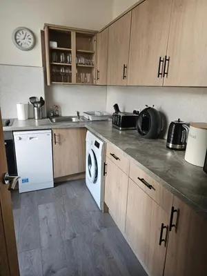 a kitchen with a washer and dryer on the counter at Ocean View in Campbeltown