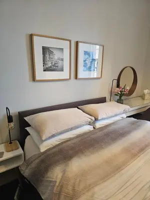two beds in a bedroom with two pictures on the wall at Ocean View in Campbeltown