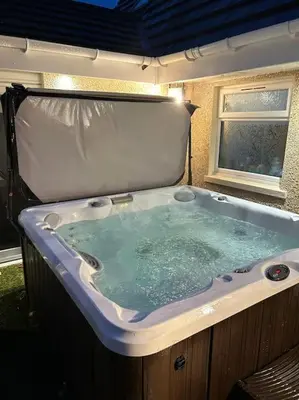 a jacuzzi tub sitting outside of a house at 101 Scotia Rooms in South Cobbinshaw