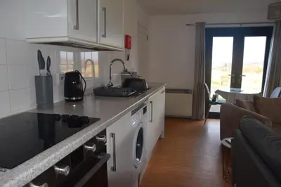 a kitchen with a counter top with a washing machine at The Stable at Drumachro in Isle of Gigha