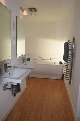 a bathroom with two sinks and a bath tub at The Stable at Drumachro in Isle of Gigha