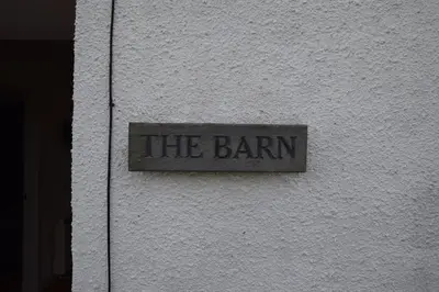 a sign on the side of a building at The Barn at Drumachro in Isle of Gigha