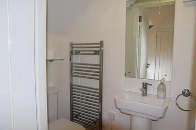 a bathroom with a sink and a toilet and a mirror at The Byre at Drumachro in Isle of Gigha